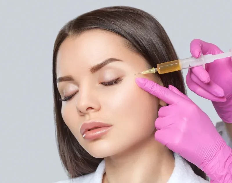 Close-up of a medical professional preparing PRP tubes for scar treatment using natural platelet therapy.